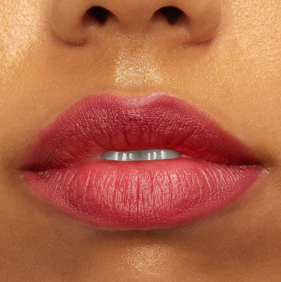 Lips wearing ColourPop Bumble Ultra Matte Lip, showing a muted rosy pink shade with full, even coverage; close-up lipstick swatch highlighting the ultra-matte finish, defined edges, and smooth texture on warm-toned skin.