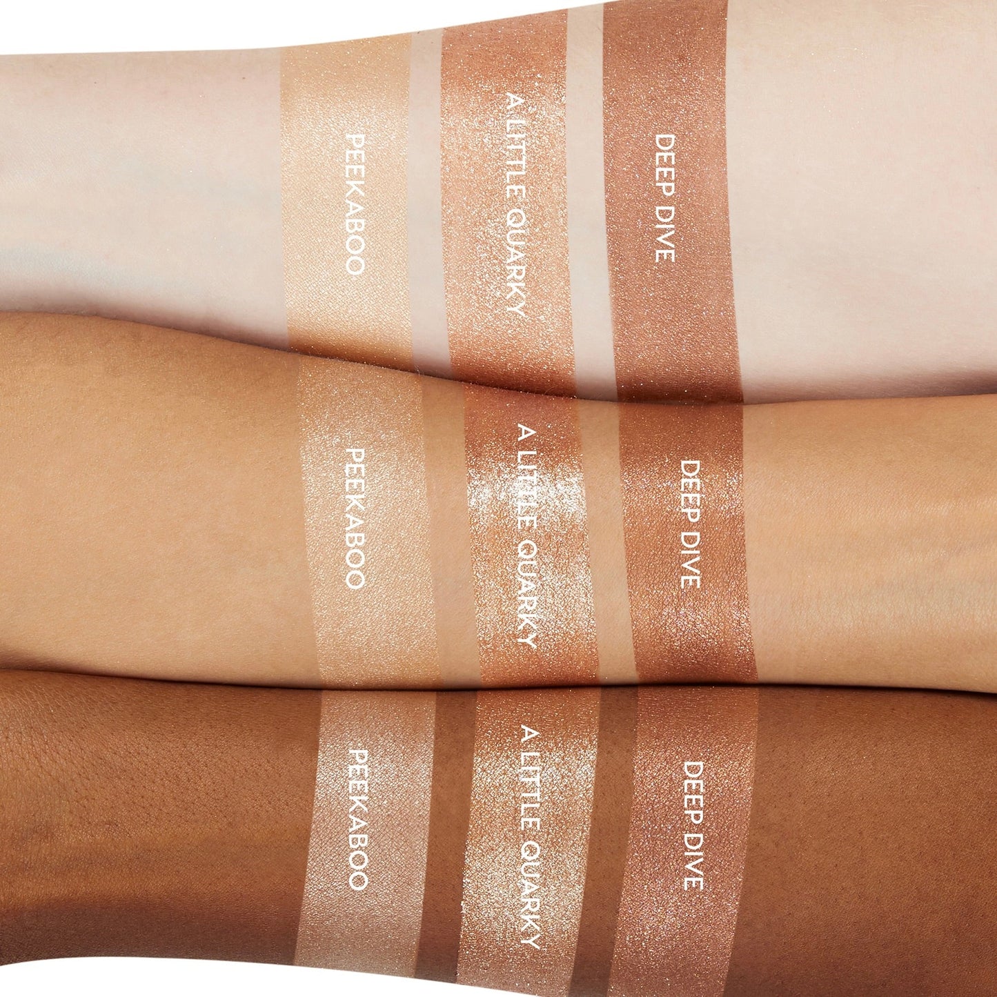 ColourPop A Little Quarky Super Shock Shadow swatched on light, medium, and deep skin, shown between Peekaboo and Deep Dive; warm champagne metallic shimmer with high shine and creamy texture, displayed in trio arm swatches for shade comparison.