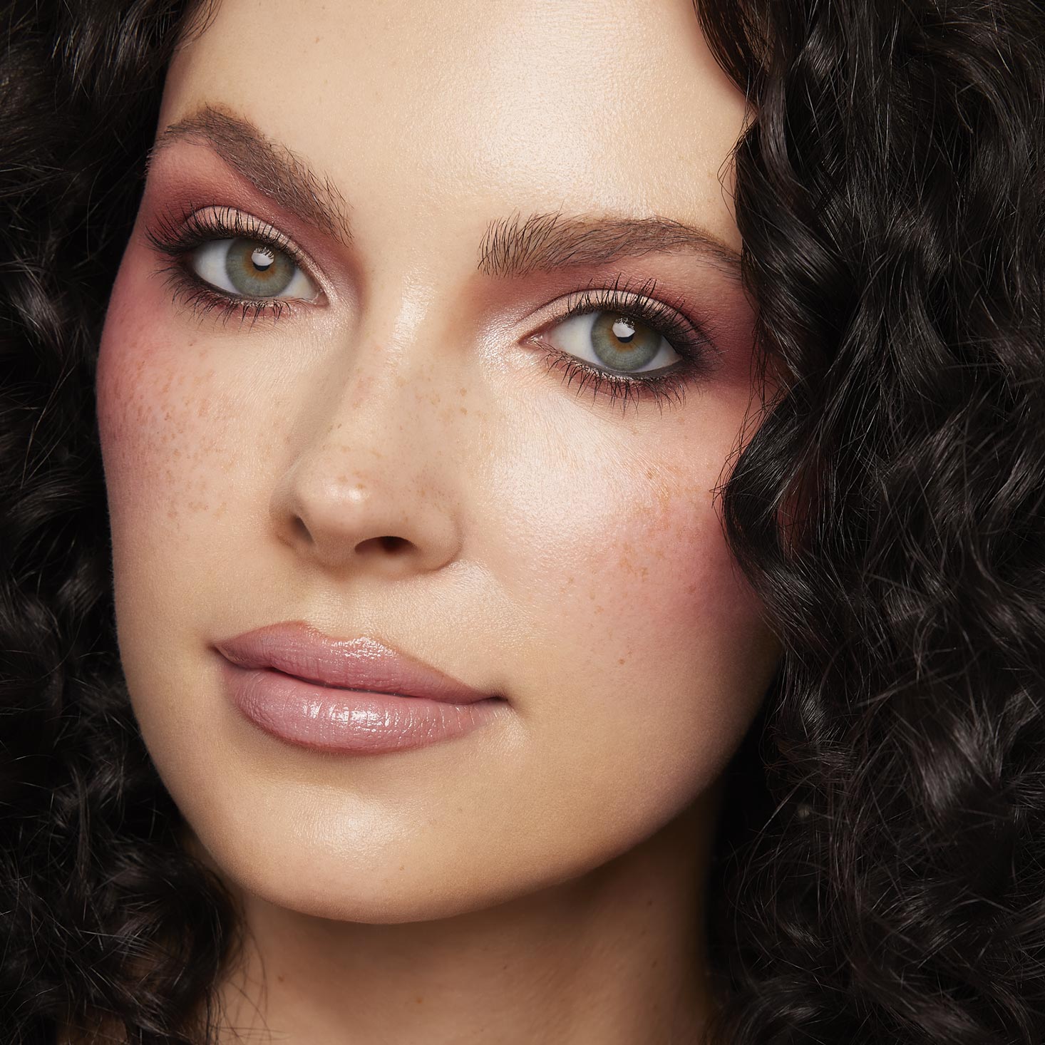 Rosy mauve eyeshadow and soft pink blush highlight a model’s eyes and cheeks, showcasing Cloud Baby ColourPop Shadow Palette Set shades with shimmer at the inner corners, wispy lashes, and nude gloss lips in a close-up studio beauty shot.